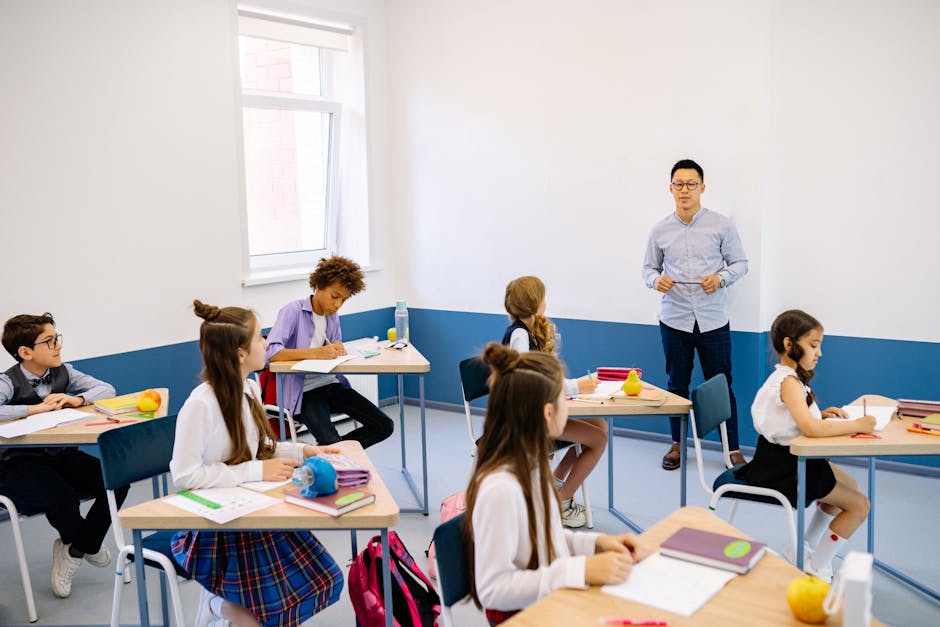 Teacher instructing a diverse group of elementary students in a modern classroom setting
