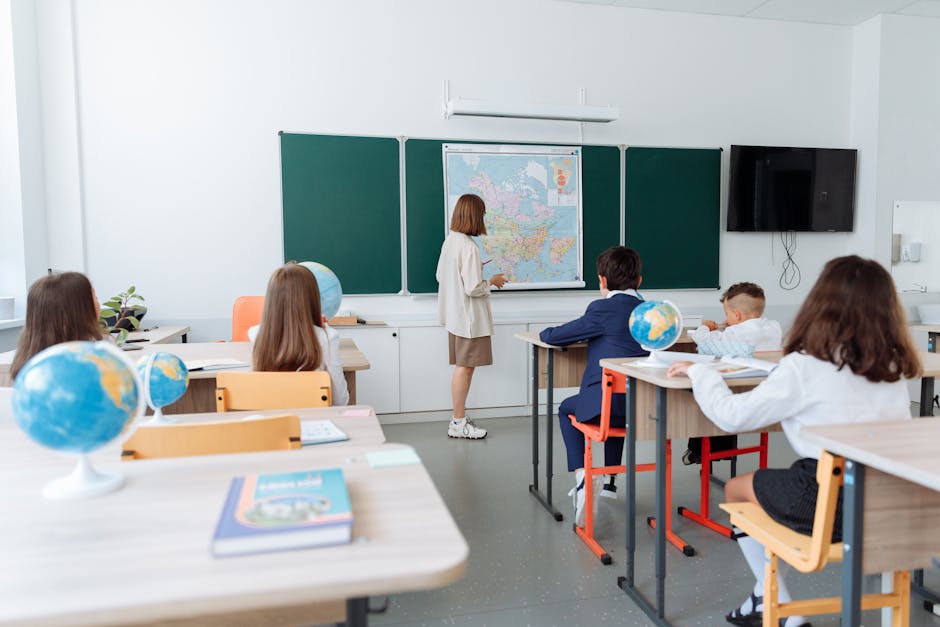 Students engaged in a geography lesson, focusing on a wall map in a classroom with globes and study materials